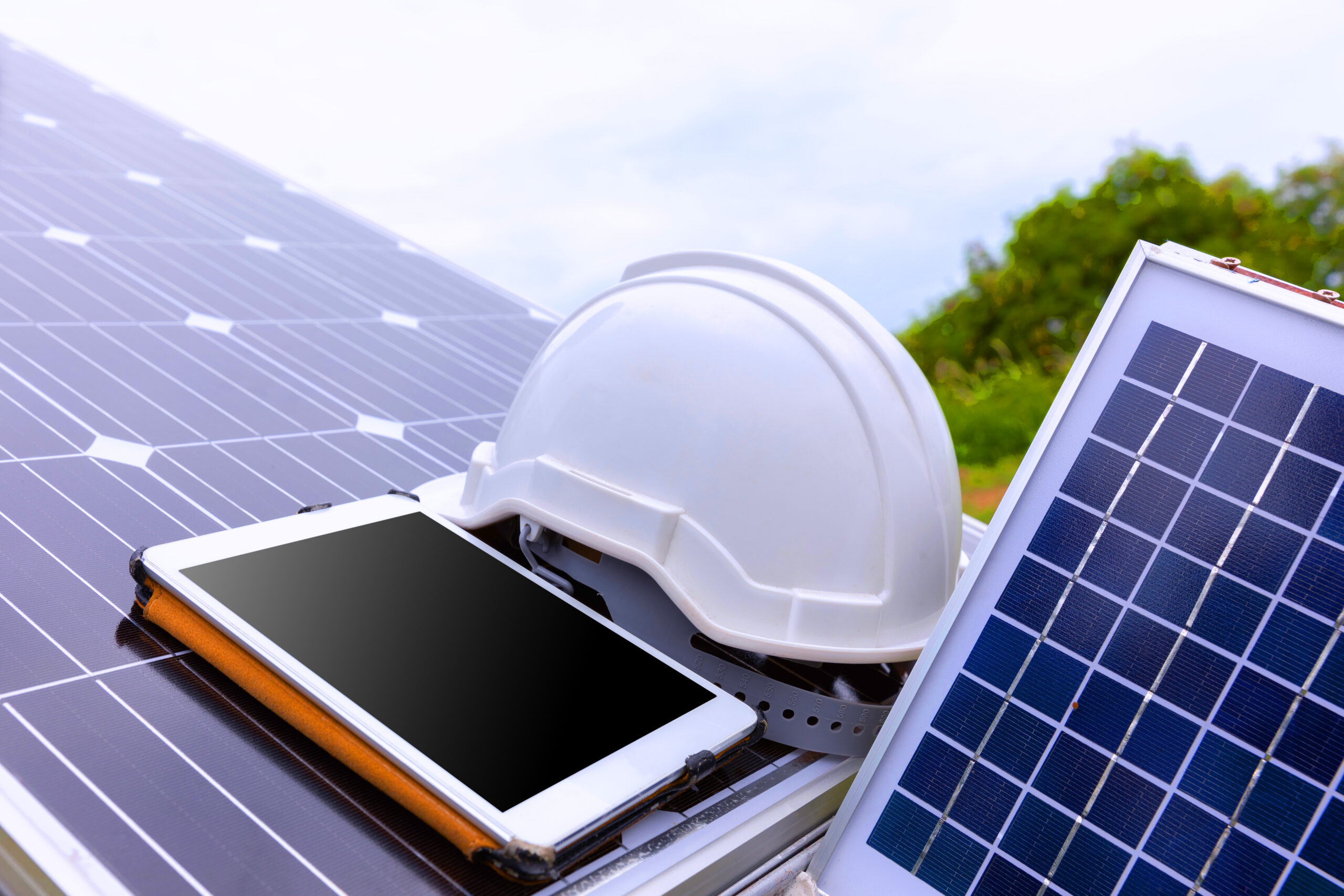 solar photovoltaic panels station checks with tablet computer scaled